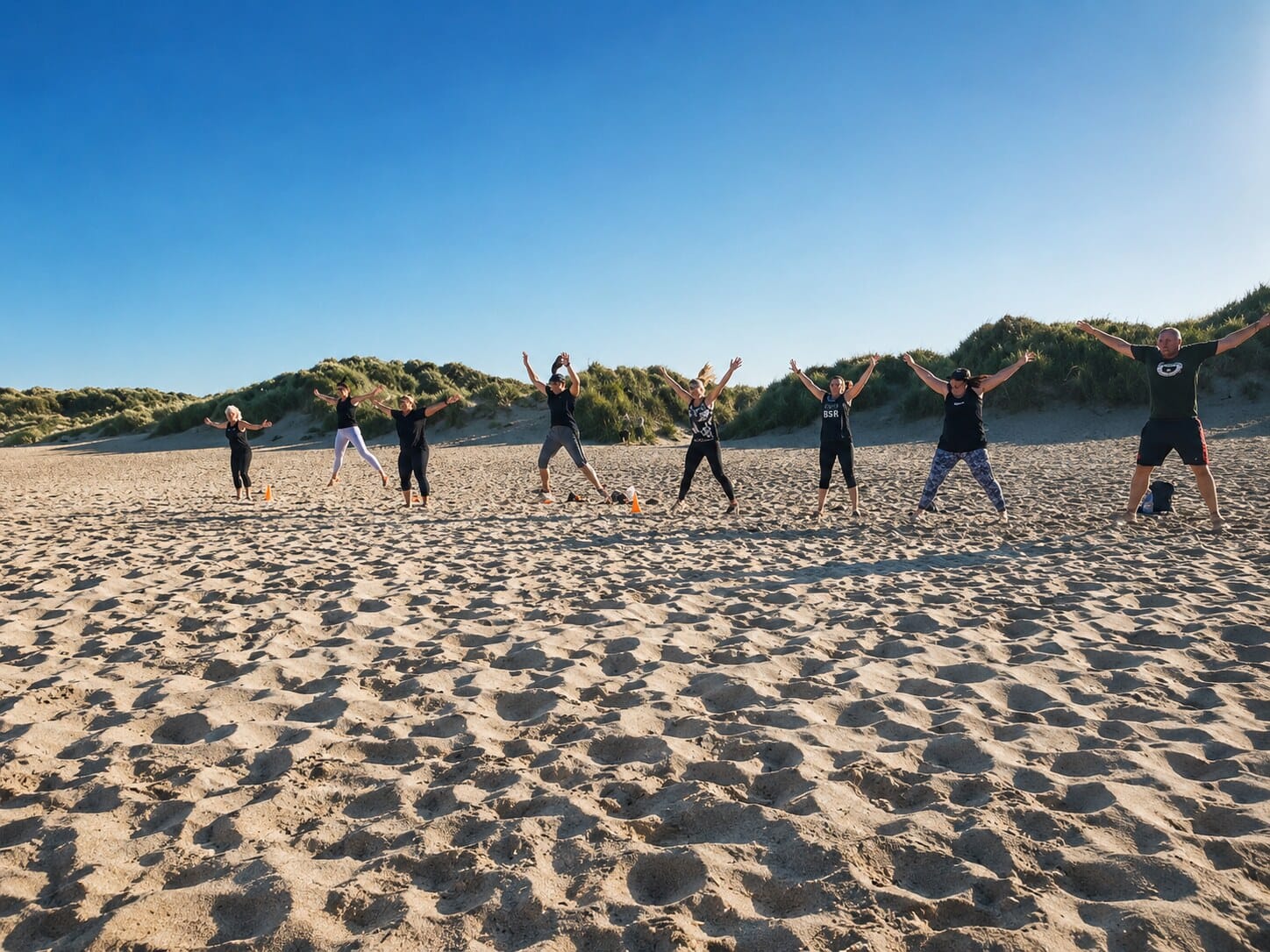 A Bleggze bootcamp group training together on the beach