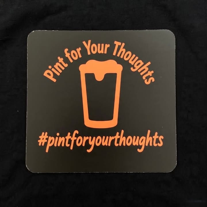 The Pint for Your Thoughts coaster: an orange pint glass on black with the hashtag pintforyourthoughts